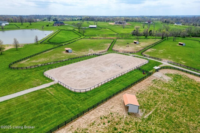 birds eye view of property with a water view and a rural view