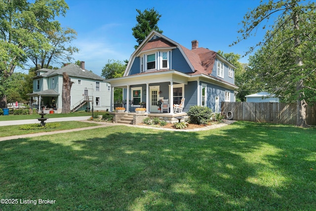 205 Birch Ave, La Grange, KY 40031 - view of front of property with fence, covered porch, a gambrel roof, and a front lawn
