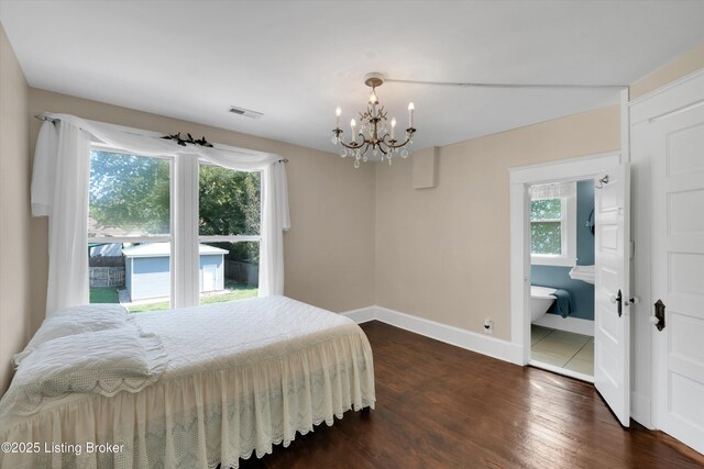 205 Birch Ave, La Grange, KY 40031 - bedroom featuring wood finished floors, connected bathroom, a chandelier, baseboards, and visible vents