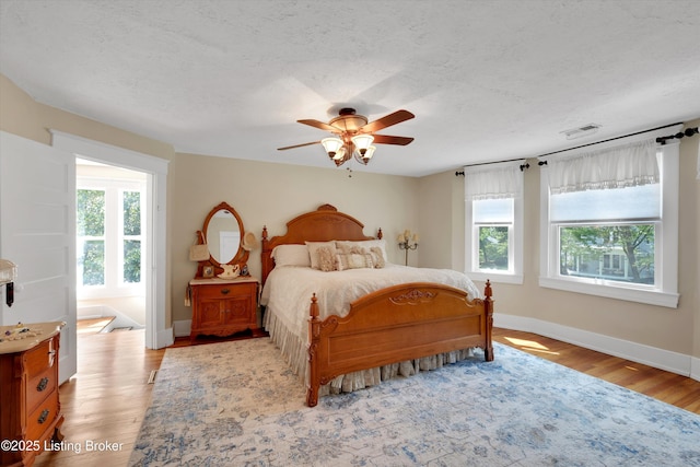 205 Birch Ave, La Grange, KY 40031 - bedroom with visible vents, baseboards, light wood finished floors, and multiple windows