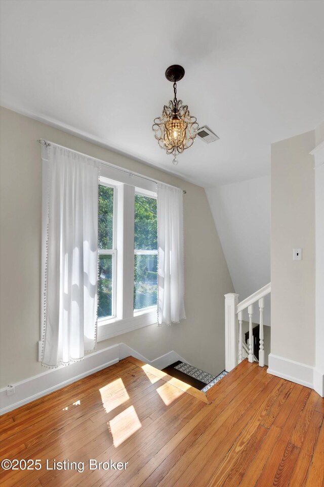 205 Birch Ave, La Grange, KY 40031 - additional living space with hardwood / wood-style flooring, visible vents, baseboards, an inviting chandelier, and vaulted ceiling