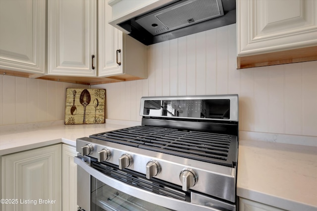 205 Birch Ave, La Grange, KY 40031 - kitchen with light countertops, stainless steel range with gas cooktop, white cabinetry, and range hood