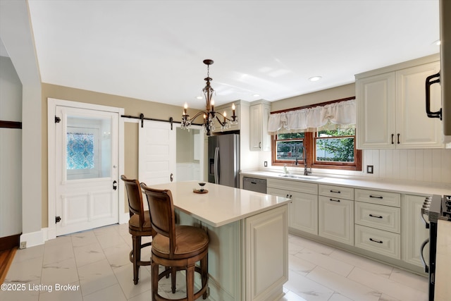 205 Birch Ave, La Grange, KY 40031 - kitchen with a sink, a barn door, stainless steel appliances, light countertops, and marble finish floor