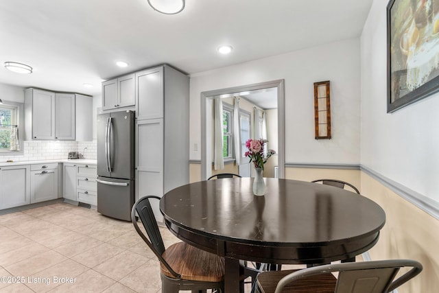dining space with recessed lighting and light tile patterned floors