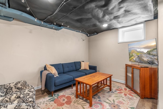 living room with baseboards and wood finished floors