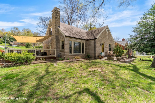 view of side of home with a wooden deck, a lawn, and a chimney
