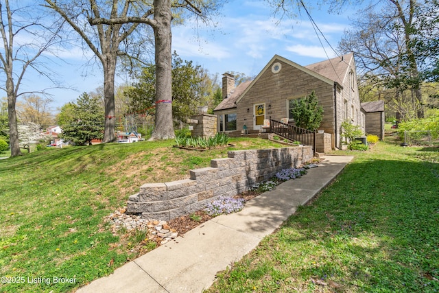 view of side of home featuring a lawn and a chimney
