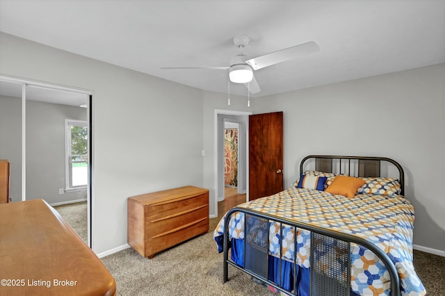 bedroom with a closet, baseboards, a ceiling fan, and carpet floors