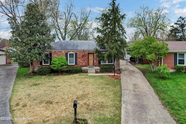 single story home with concrete driveway, brick siding, and a front lawn