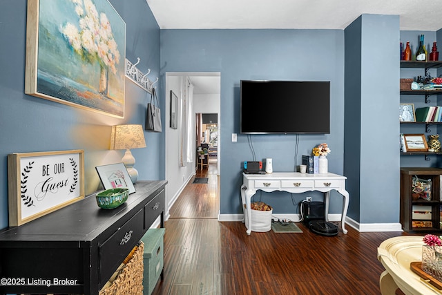 living area featuring wood finished floors and baseboards