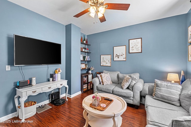 living room with baseboards, wood finished floors, and ceiling fan