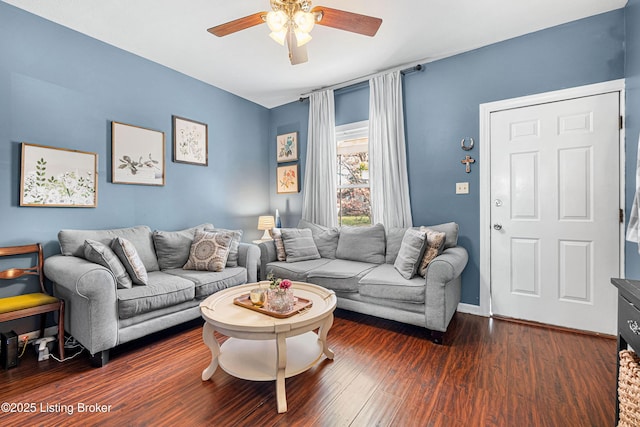 living area with baseboards, dark wood-style floors, and ceiling fan