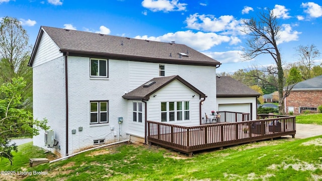back of house featuring brick siding, a yard, and a deck