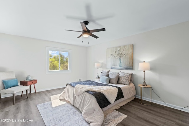 bedroom featuring wood finished floors, baseboards, and ceiling fan
