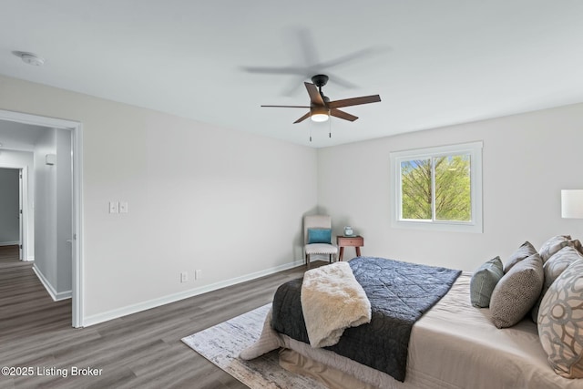 bedroom with wood finished floors, baseboards, and ceiling fan