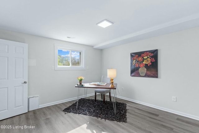 office with baseboards, wood finished floors, and visible vents