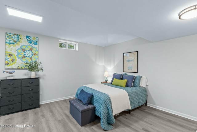 bedroom featuring light wood-style flooring and baseboards