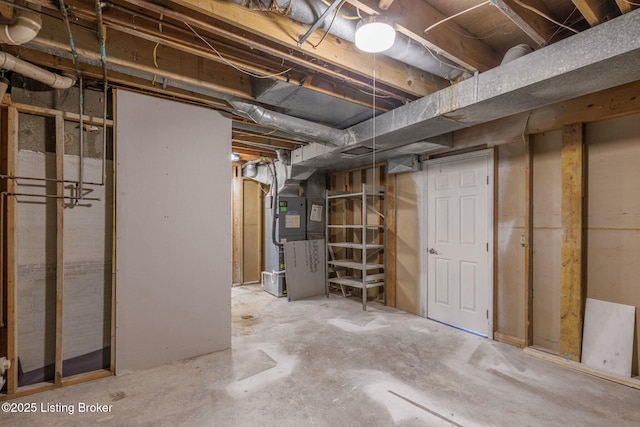 unfinished basement featuring heating unit
