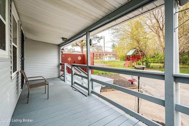 deck with fence and a playground