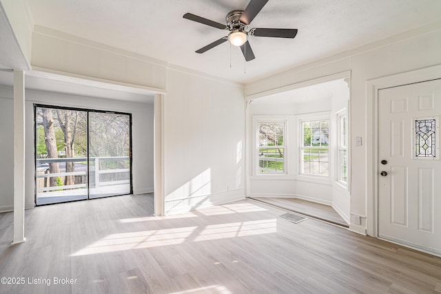 interior space with baseboards, wood finished floors, and ceiling fan