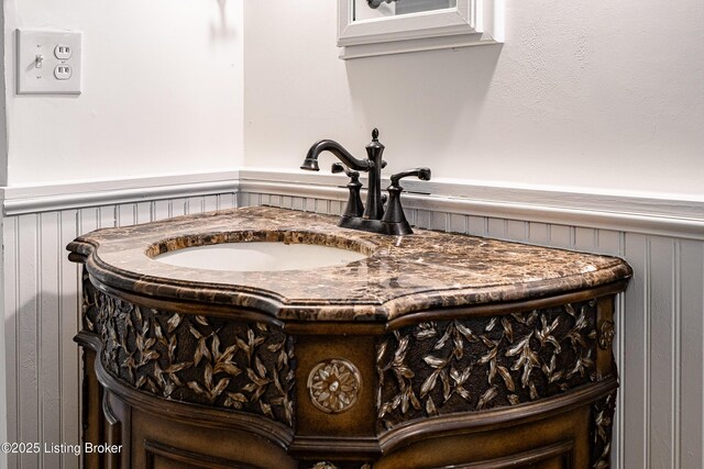 room details with wainscoting and a sink
