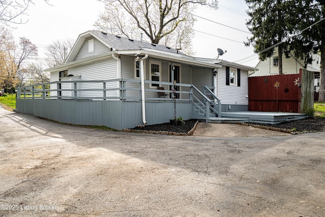 view of front facade with a porch and fence