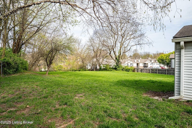 view of yard with fence and a residential view
