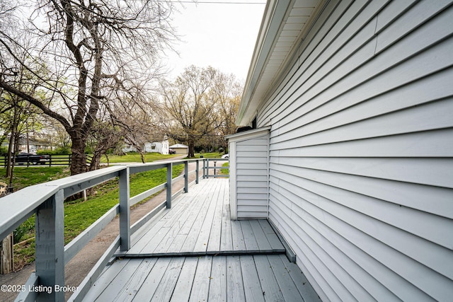 deck featuring a lawn and fence