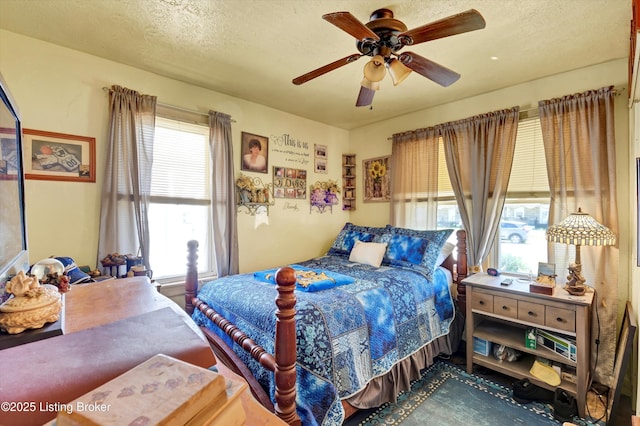 bedroom with a textured ceiling and a ceiling fan