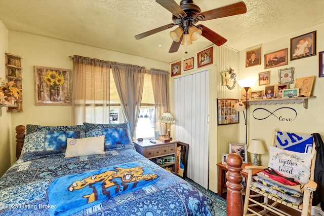 bedroom with a textured ceiling and ceiling fan