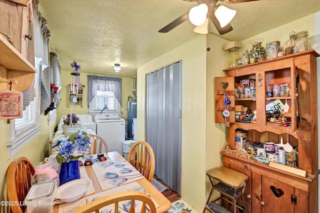 dining space with washer and clothes dryer, wood finished floors, gas water heater, a textured ceiling, and ceiling fan