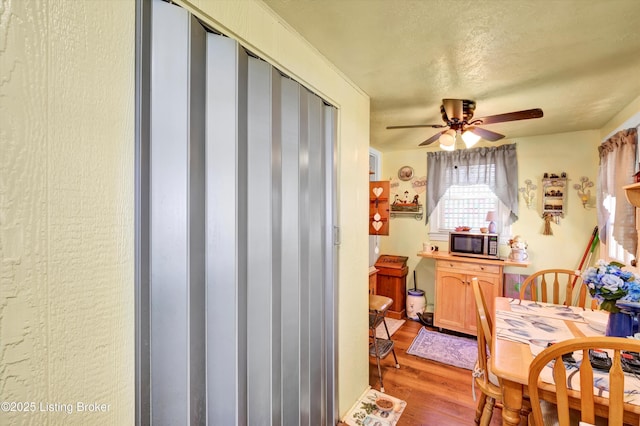 dining room with light wood-type flooring and ceiling fan