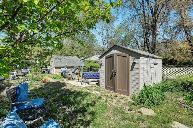 view of shed with fence