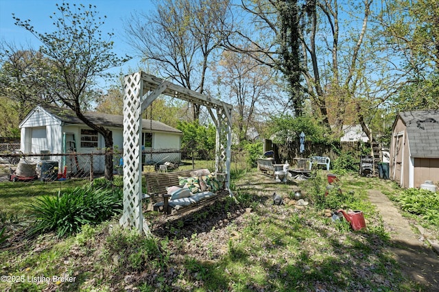 view of yard featuring fence, an outbuilding, and a storage shed