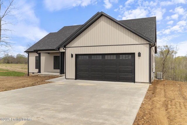 modern farmhouse style home featuring a shingled roof, driveway, cooling unit, and an attached garage