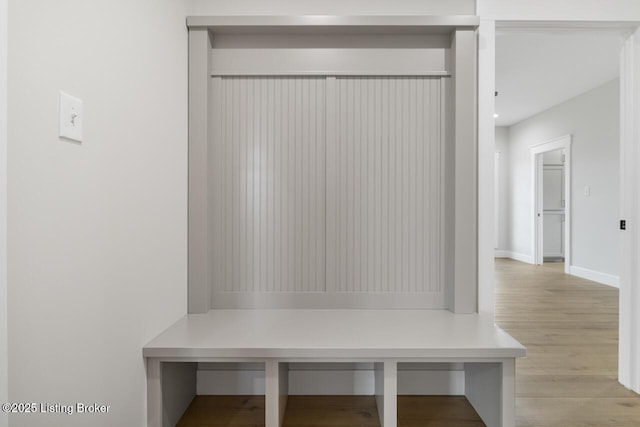mudroom featuring baseboards and wood finished floors