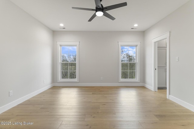 empty room with light wood finished floors, a ceiling fan, visible vents, and recessed lighting