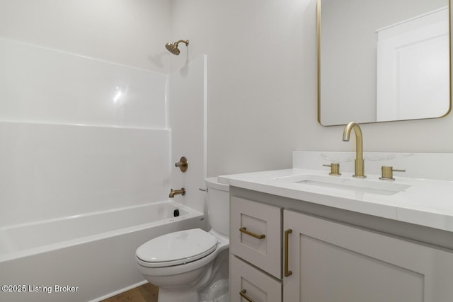 full bathroom with washtub / shower combination, vanity, toilet, and wood finished floors