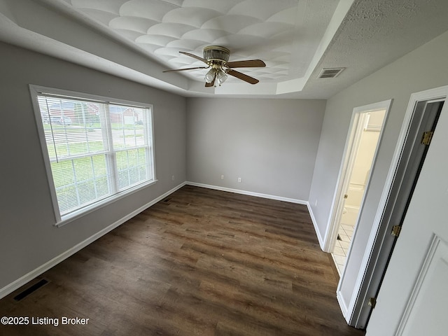 7213 Hassock Dr, Louisville, KY 40258 - unfurnished bedroom with dark wood-style flooring, visible vents, baseboards, and a tray ceiling