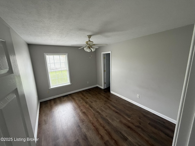 7213 Hassock Dr, Louisville, KY 40258 - unfurnished bedroom with a textured ceiling, baseboards, dark wood finished floors, and visible vents