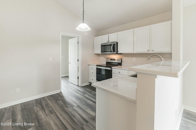 kitchen featuring dark wood-style flooring, appliances with stainless steel finishes, vaulted ceiling, and white cabinetry