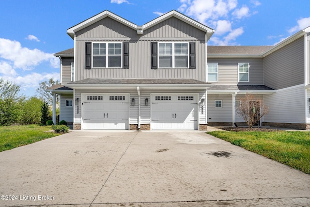 view of front of home with an attached garage, board and batten siding, and concrete driveway