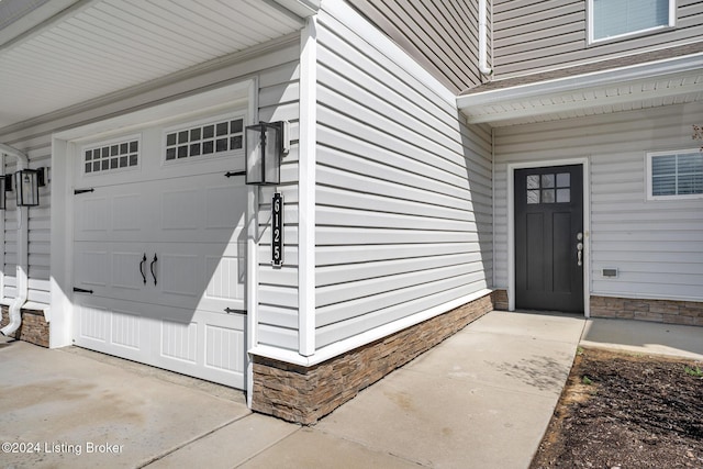 view of exterior entry featuring stone siding