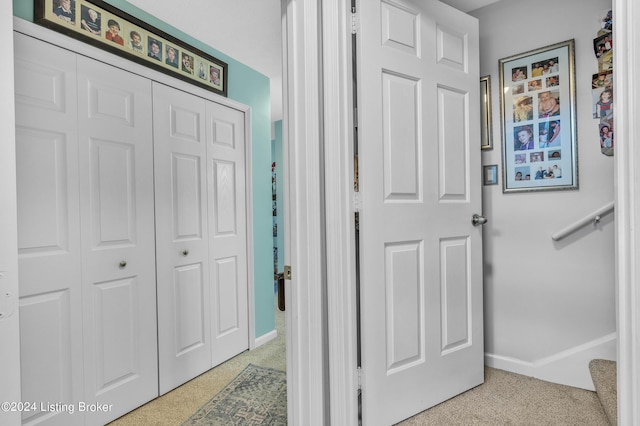 interior space featuring light colored carpet and baseboards