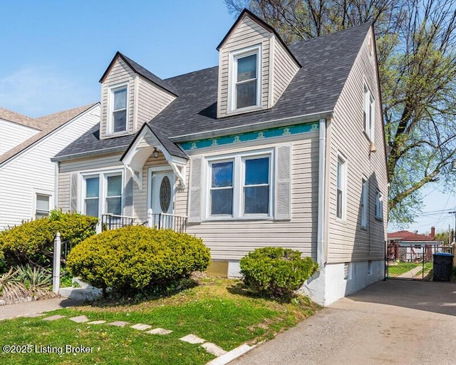 new england style home featuring roof with shingles