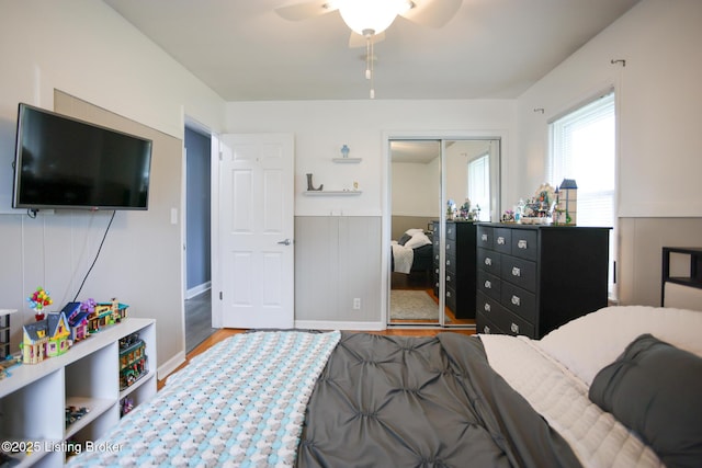 7407 Meadow Rd, Crestwood, KY 40014 - bedroom featuring wood finished floors, a closet, a wainscoted wall, and a ceiling fan