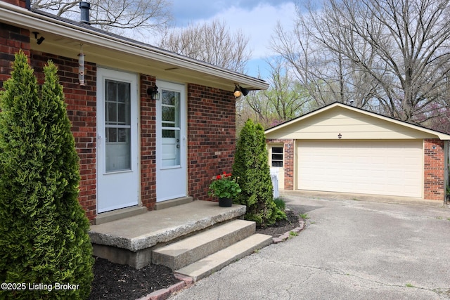 7407 Meadow Rd, Crestwood, KY 40014 - doorway to property featuring brick siding, a garage, and driveway