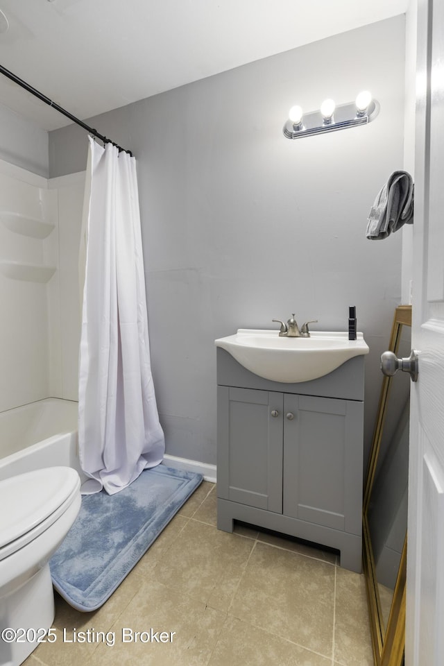 bathroom with baseboards, toilet, vanity, and tile patterned floors