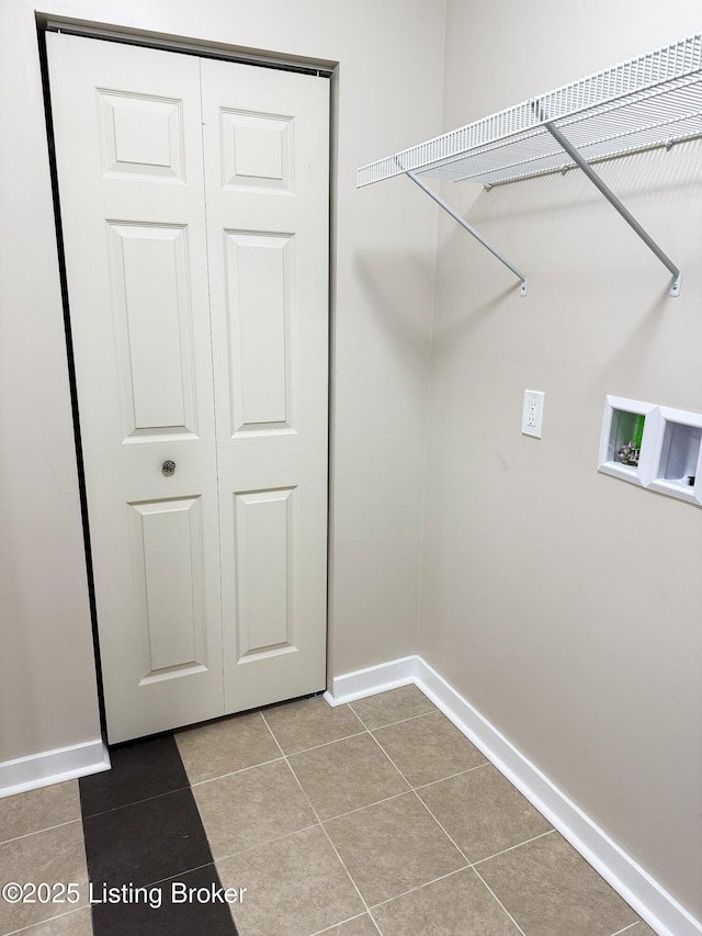 laundry area with washer hookup, tile patterned flooring, baseboards, and laundry area