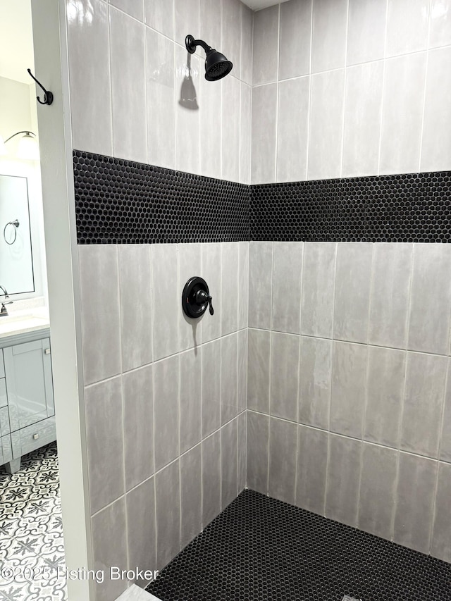 full bath with vanity and a tile shower